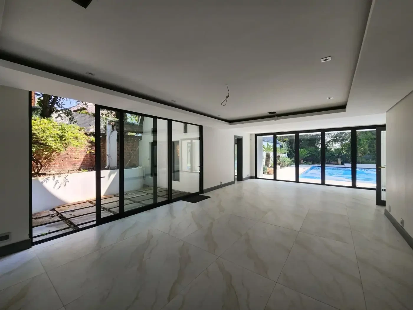 vaga series slim profile black aluminium sliding doors interior VAGA Series slim profile black aluminium sliding doors contemporary interior maximum glass area